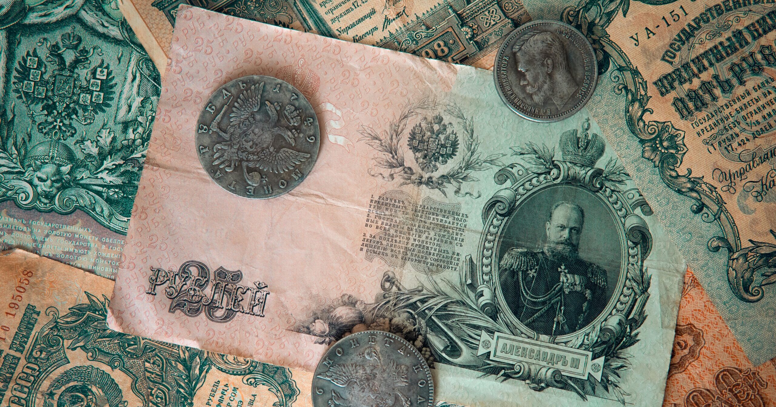 Rare coinage and historic postage stamps, demonstrating the enduring value of numismatic and philatelic portfolios.