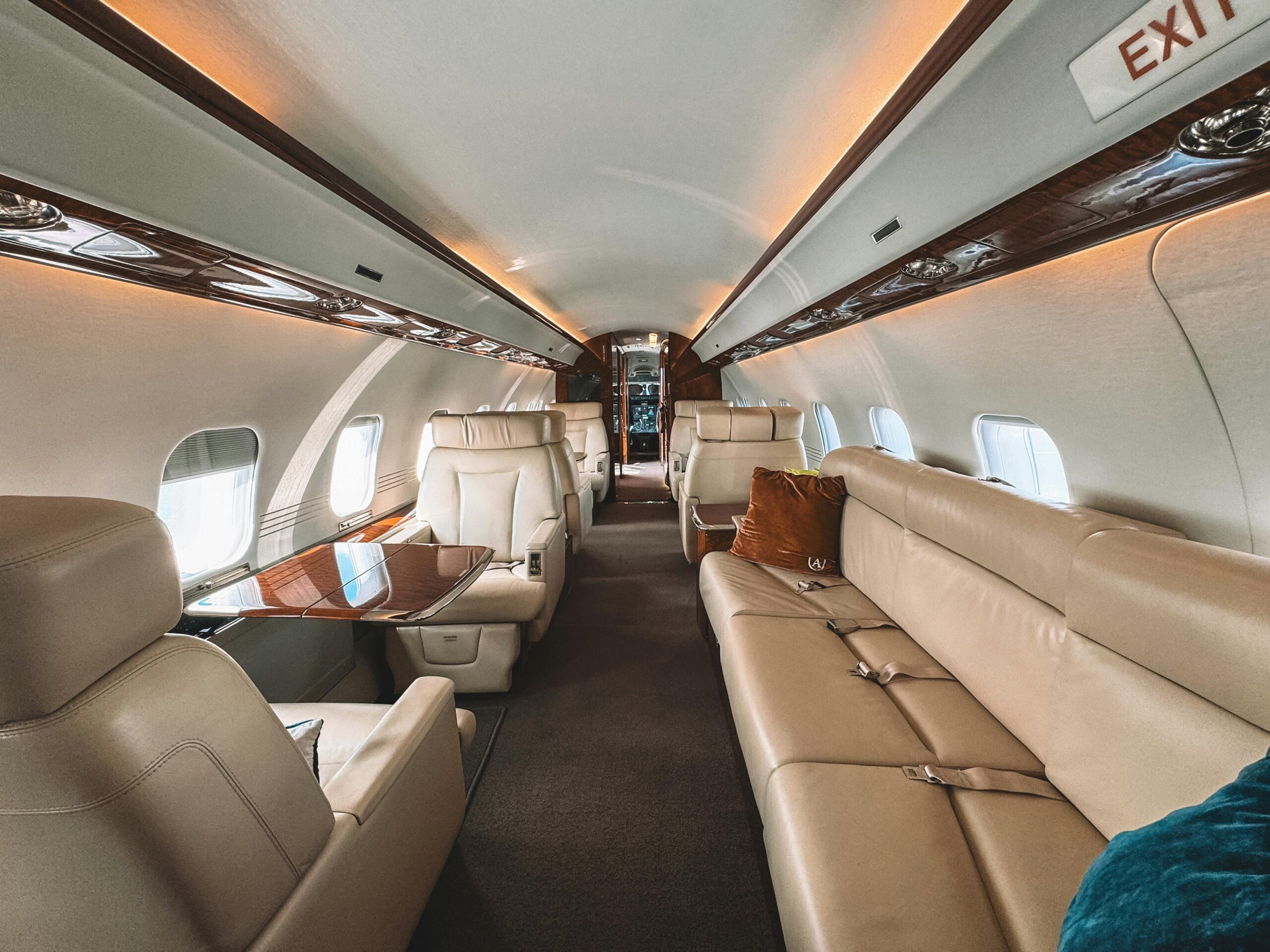 Luxury private jet cabin interior, a symbol of full ownership and the high cost fueled by celebrity and mogul travel.