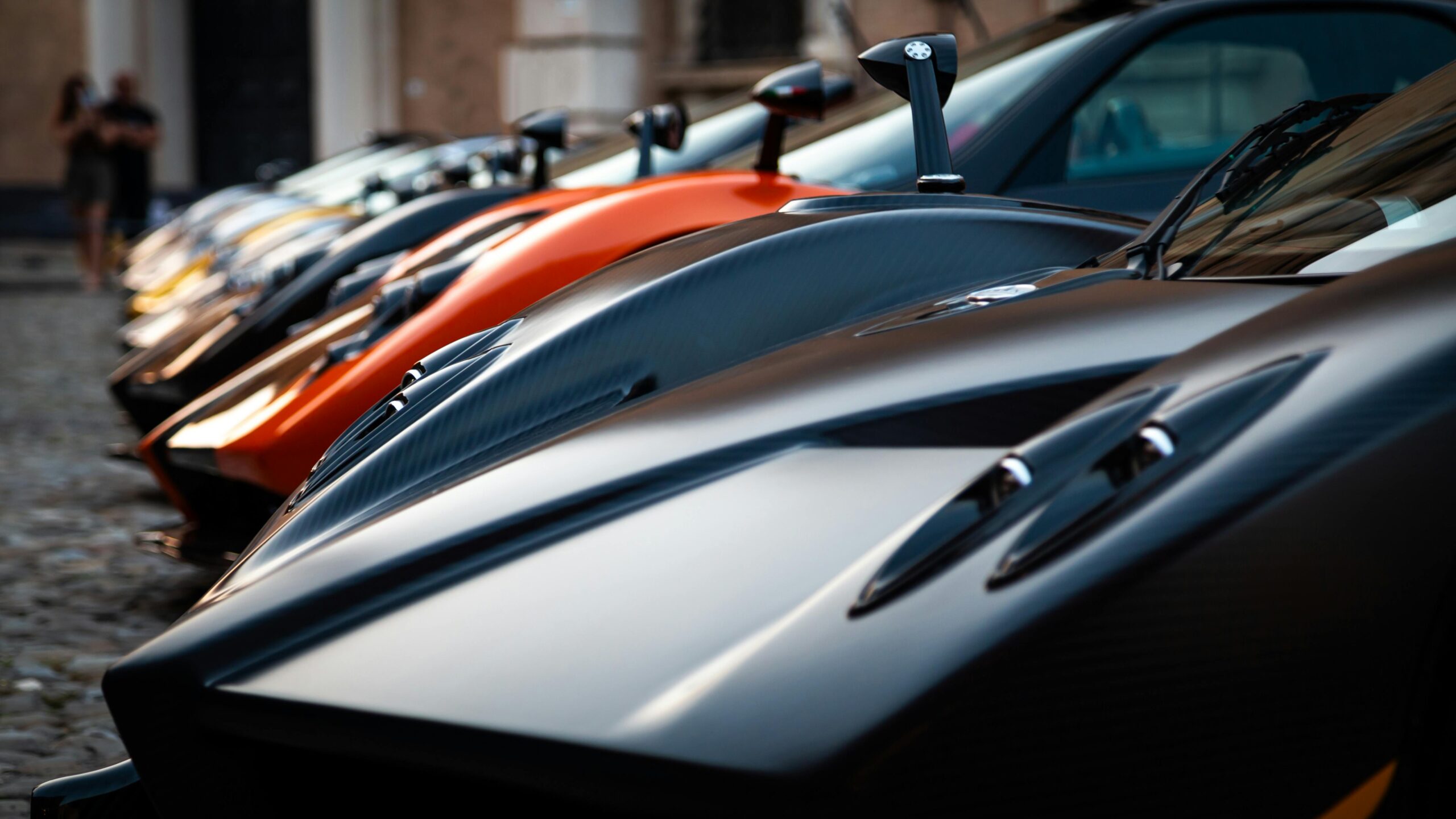 A collection of hypercars parked in an ultimate celebrity garage, reflecting the true cost of ownership and hidden wealth.